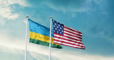 Ruanda ve ABD bayrakları rüzgarda dalgalanıyor bulutlu mavi gökyüzüne karşı