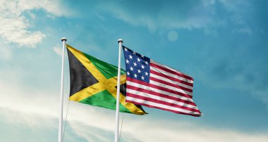 Jamaika ve ABD bayrakları mavi gökyüzü arka planında 