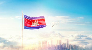 Kamboçya ulusal bayrağı güzel bina siluetinde dalgalanıyor. 