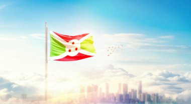 Burundi ulusal bayrağı gökyüzünde dalgalanıyor. 