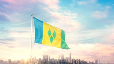 Saint Vincent ve Grenadines bayrağı şehrin arka planında dalgalanıyor 