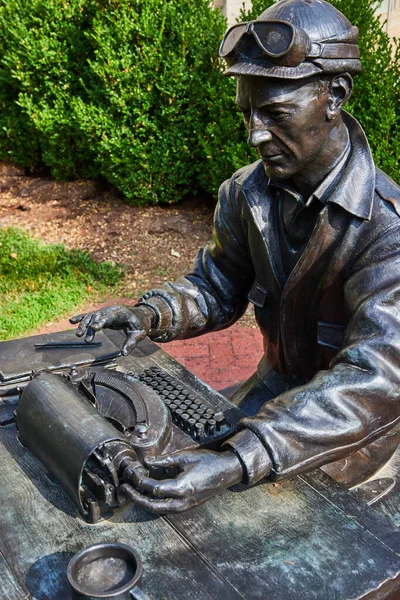 Image of Indiana University exterior art statue of person on typewriter
