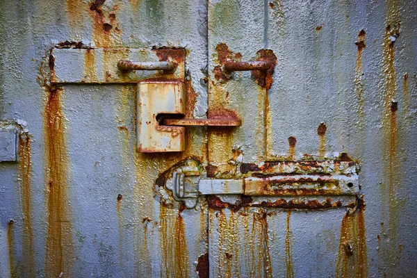 Image of Detail of old mine entrance door made of steel and rusting