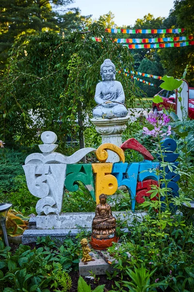 Image of Foreign colorful letters and Buddha statues in prayer and meditation garden for Tibetan Mongolian Buddhist shrine