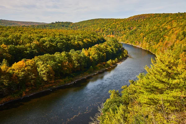 Image of Delaware river in early fall with signs of yellow trees