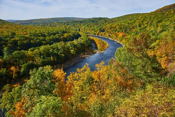Image of Beautiful Delaware River winding through lush green forest in early fall