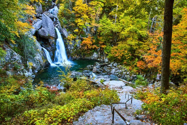 Image of Stairs leading down to beautiful waterfall in fall forest of New York