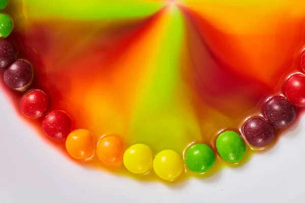 Image of Half circle Skittle ring vibrant rainbow colors swirl toward center background asset abstract