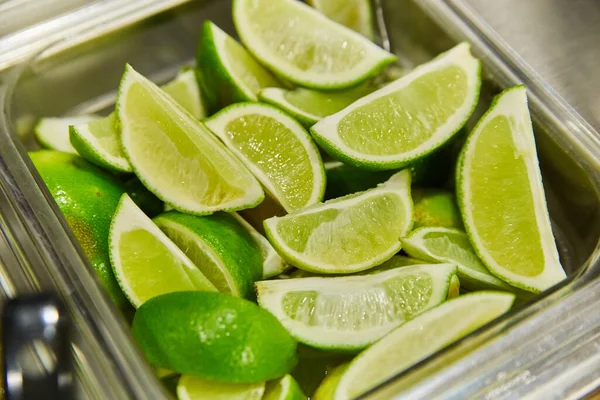 Image Vibrant Green Lime Wedges Cut Silver Cambro Square Container — Stock Photo, Image