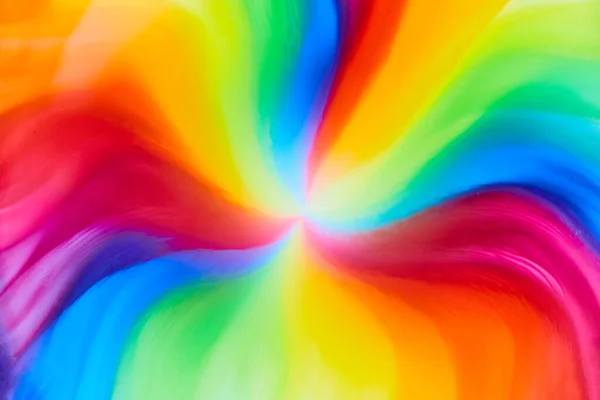 Image of Horizontal of rainbow tie die colors from skittles water and color as candy and sugar dies create psychedelic hippie background