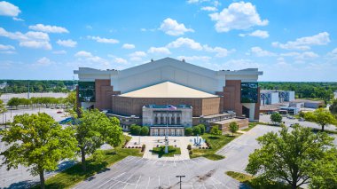 Image of Aerial Allen Country War Memorial Coliseum with airplane and American flag and blue sky day clipart