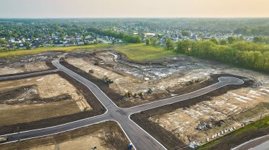 Image of Housing construction aerial bulldozer, bobcat cul-de-sac with paved road distant houses neighborhood clipart