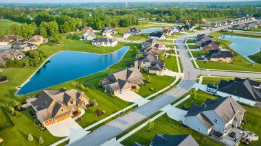 Image of Aerial large ponds in rich expensive neighborhood with mini mansions, high-end, million-dollar homes clipart