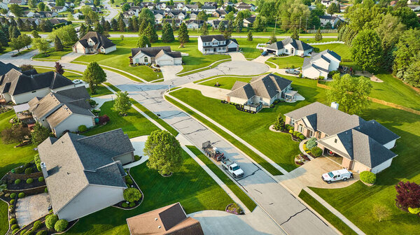Image of Fresh cut lawns expensive neighborhood with landscaping on property