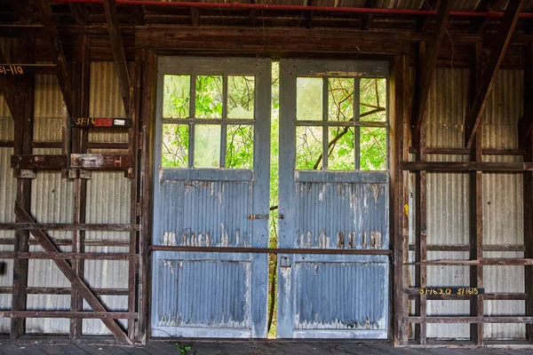 Image of Double doors, barn doors, abandoned, broken, barn, unit, spare machinery storage, interior
