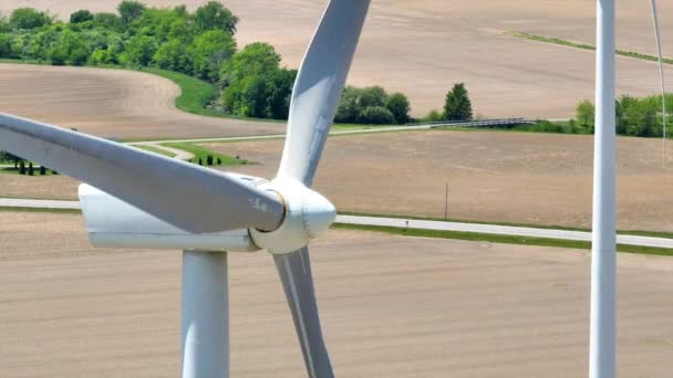 Video Close Aerial Video Spinning Wind Turbine Blades Distant Farm — Stock Video