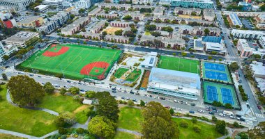 Image of Aerial apartment buildings with multiple sport fields and courts in San Francisco clipart