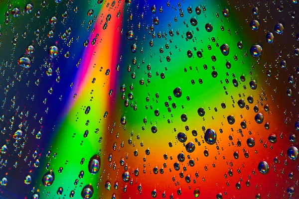 Image of Beam of light across abstract rainbow colored background with rain drops background asset