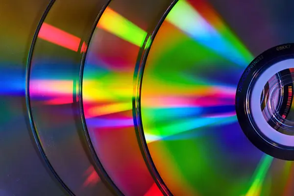 Image Abstract Stack Four Silvery Cds Reflective Rainbow Colored Bursts — Stock Photo, Image