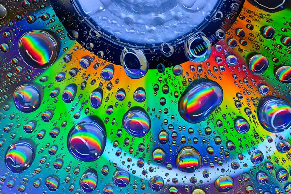 Image of Floating bubbles atop bright colorful metallic surface in abstract background asset