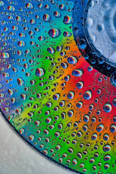Image of Bright and vibrant metallic surface with fizzy bubbles on abstract CD surface in background asset