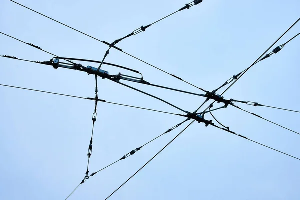 Image of Connecting wires for clean city transportation upward abstract view with overcast sky