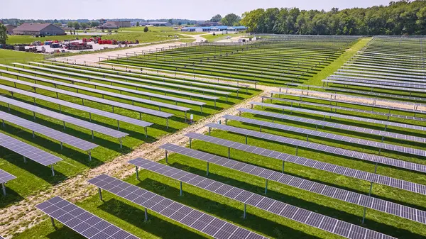 Image of Low aerial of solar farm with panels on summer day in rural area of Midwest