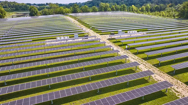 Image of Midwest solar farm with rows of solar panels on sunny day
