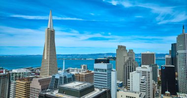 Transamerica Piramidinin resmi gökdelenlerin yanında bulutlu mavi gökyüzü ve San Francisco Körfezi, CA