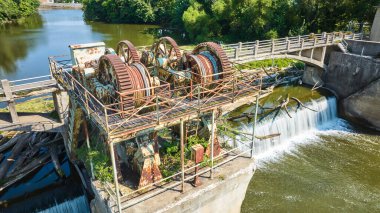 Maumee Nehri Barajı 'ndaki Paslı dişlilerin görüntüsü şelaleden geçip Fort Wayne, IN' e giden ağaçların görüntüsü.