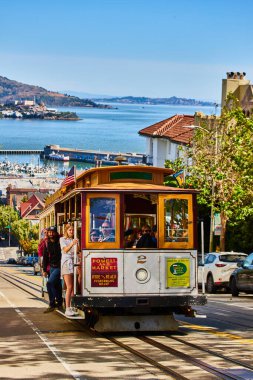 San Francisco Körfezi 'ndeki Alcatraz Adası' nda tramvayın dışında tutunan turistlerin görüntüsü