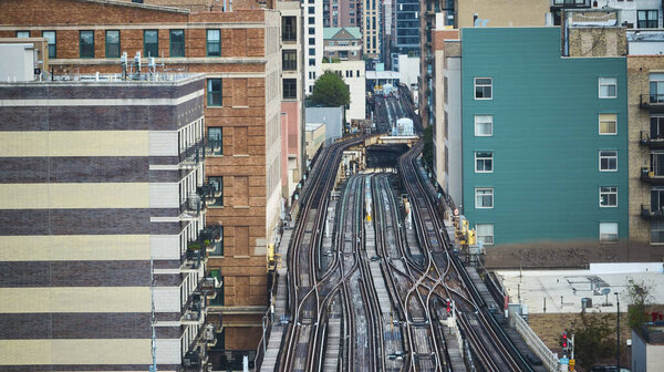 Image of Empty train tracks in city, travel, transportation with aerial of buildings lining railroad, Chicago