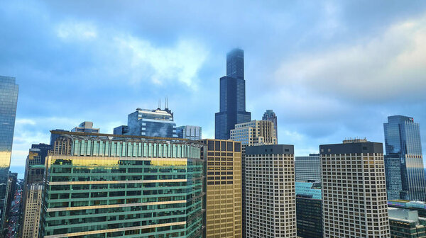 Image of Chicago aerial skyscrapers with pretty blue sky and clouds over downtown buildings, tourism