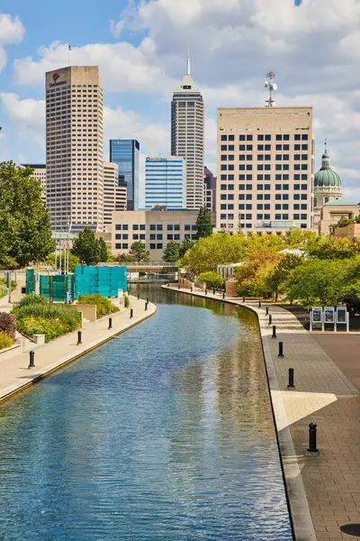 stock image Sunny day in Indianapolis 2023, showcasing a tranquil canal amidst bustling skyscrapers, defining modern urban living.