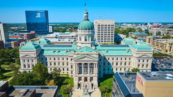 Stock image Aerial view of an imposing government courthouse with green copper dome in downtown Indianapolis, contrasting with modern skyscrapers, captured by a DJI Mavic 3 drone in 2023