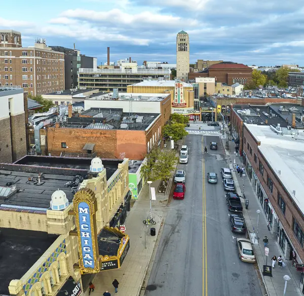 stock image Vibrant aerial view of historic Michigan Theater and Burton Memorial Tower in Downtown Ann Arbor, showcasing a blend of architectural styles and everyday urban life.