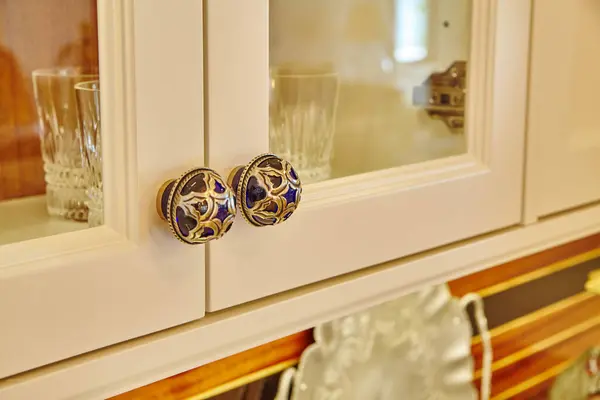 Elegant Blue and Gold Cabinet Knobs on Cream Cabinetry in Cozy Indiana Home Interior, 2015