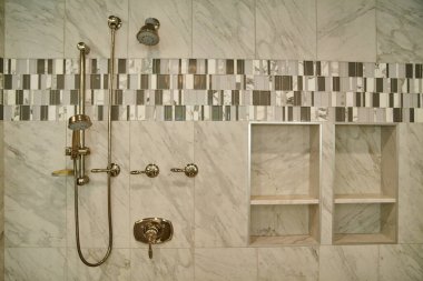 Modern Luxurious Bathroom in Michigan Home Showcases Opulent Brass Fixtures and Elegant Marble Tile Design, 2015 clipart