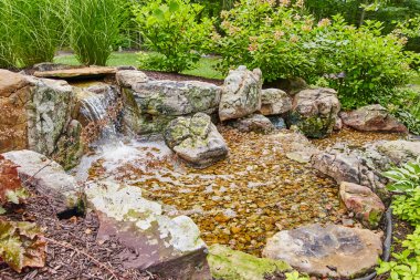 Huntertown, Indiana 'da dizayn edilen çağlayan şelale ve yemyeşil bitki örtüsü ile serin arka bahçe su özelliği, 2015