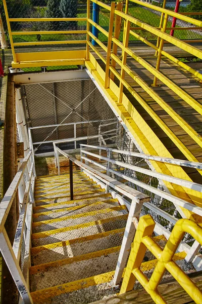 Vibrant Industrial Staircase in Abandoned Angolan Roller Coaster, 2015 - A Study of Urban Decay and Time