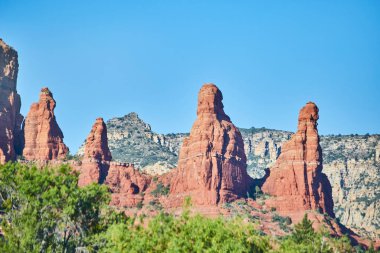 Sedona, Arizona 'da berrak gökyüzü altında gündüz vakti görülen görkemli kızıl kaya oluşumları eşsiz jeolojik güzellikleri ve çöl manzaralarını gözler önüne seriyor..