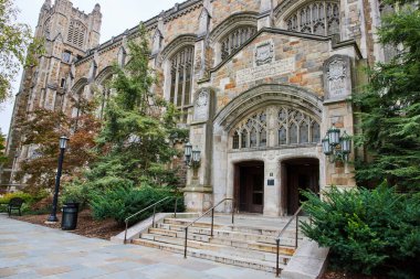 Ann Arbor 'daki Gotik tarzı Michigan Üniversitesi Hukuk Fakültesi Binası girişi zengin taş işçiliği ve yemyeşil alanlarla vurgulanmış..