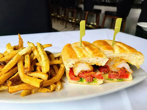 Delicious gourmet sandwich with seasoned fries in Fort Wayne, Indiana restaurant, 2023