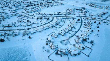 Aerial Winter Splendor in Fort Wayne, Indiana - Snow-kissed Residential Neighborhood Embracing Seasonal Tranquility clipart