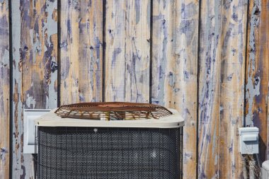Rustic, Spiceland, Indiana 'da soyulmuş bir barnwood duvarına karşı yıpranmış bir klima ünitesiyle modern bir karşılaşma yapıyor..