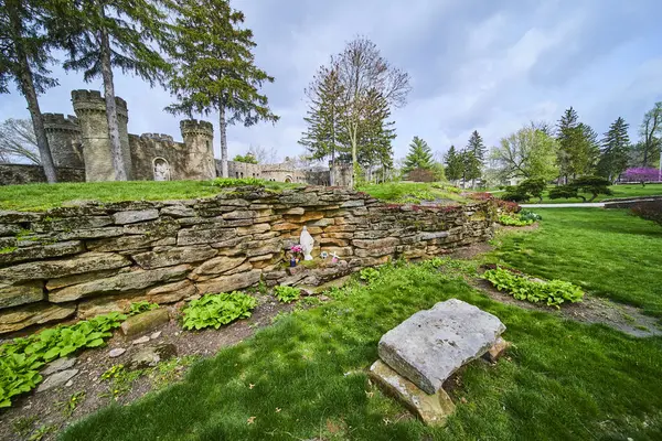 Stock image Springtime serenity at Indianas Bishop Simon Brute College, with figure in white in peaceful contemplation amidst historic architecture and verdant gardens