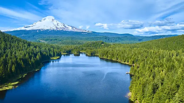 stock image Aerial view of Lake Trilliums crystal-clear waters surrounded by lush forests with majestic Mount Hood towering in the background. Experience the serene beauty of Oregons pristine landscape. Perfect