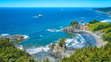 Stunning aerial view of Samuel H. Boardman State Scenic Corridor in Brookings, Oregon, showcasing rugged coastlines with dramatic rock formations, secluded beaches, and lush greenery against deep blue clipart