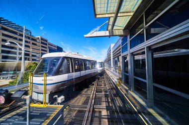 Modern trams in a sleek, sunlit station in Minneapolis, Minnesota, symbolize urban connectivity and sustainable transportation. Perfect for concepts of progress, city life, and clean energy transit clipart