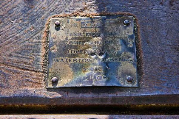 stock image Close-up of a historic Watertown Arsenal plaque on a corroded tank surface in Huntington, Indianas Charters of Freedom Park, showcasing aged military equipment from 1950 with detailed inscriptions.